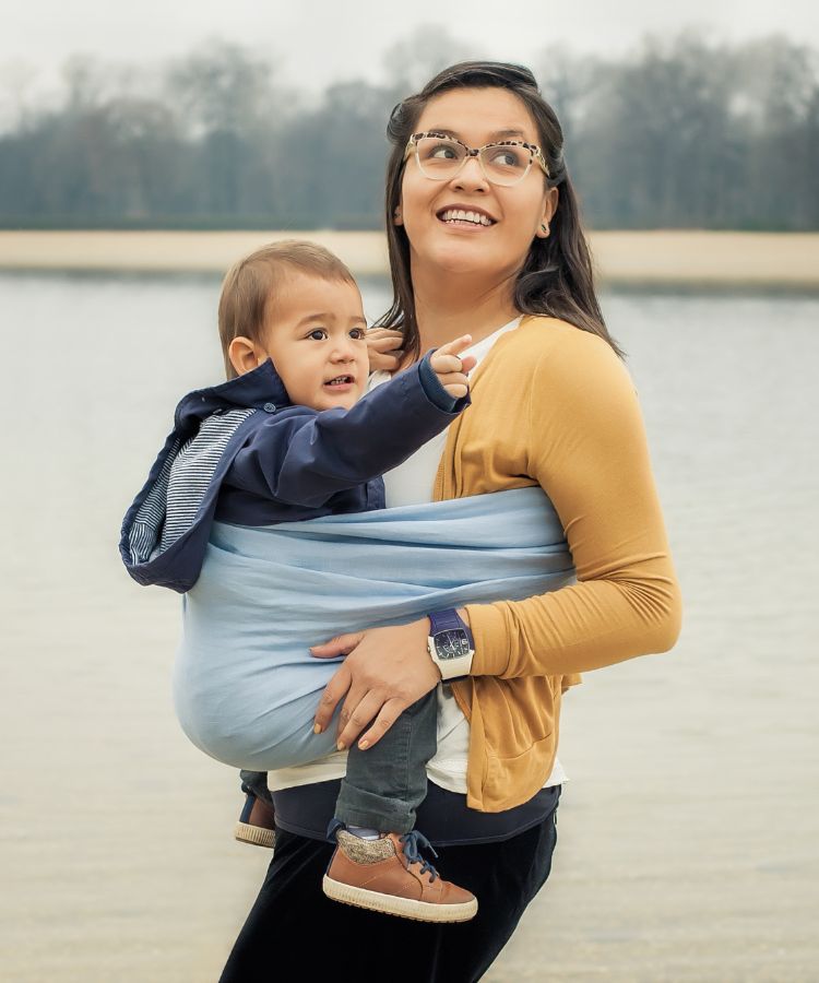 mum carrying toddler in a sling