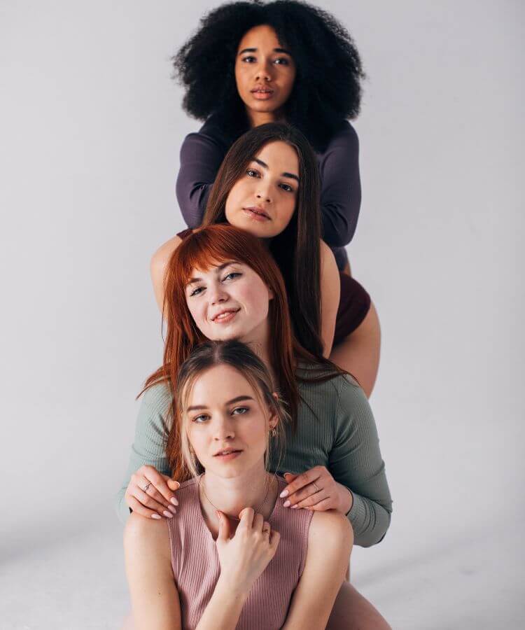 a group of women standing one behind the other but at different heights so their heads are visible
