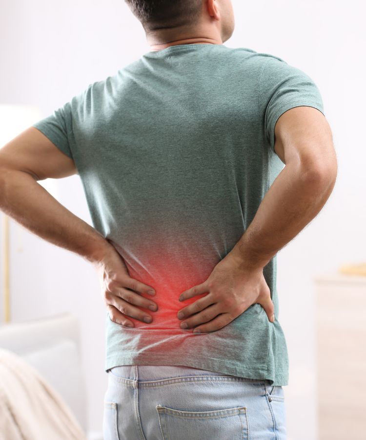 a man holding his lower back with an effect of glowing red over his loer back condition