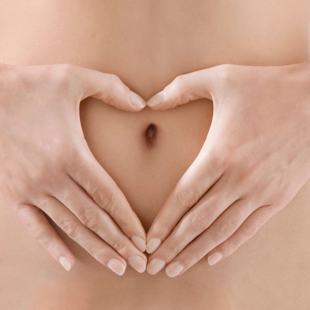 hands forming a heart shape around the tummy button